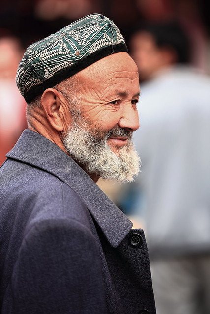 Bearded Uyghur man wearing doppa-skullcap at the city's bazaar. Hotan-Xinjiang-China-0077
