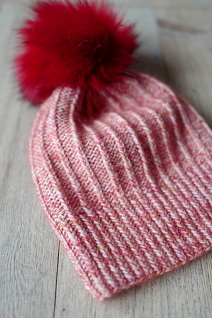 Twistmas is a fun and easy hat featuring twisted rib that is knit holding 2 strands of fingering or 1 strand of DK with 1 strand of mohair.