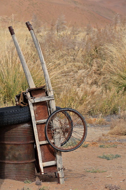 Rusty old cart leaning on oxidized oil drum-Badain Jaran Desert-China-1071