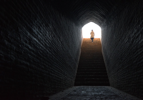 Light at the end of the keyhole, Yazd, Iran by German Vogel, Iranian woman walks toward the light from the darkness of an underground ice chamber in Yazd, Iran.
