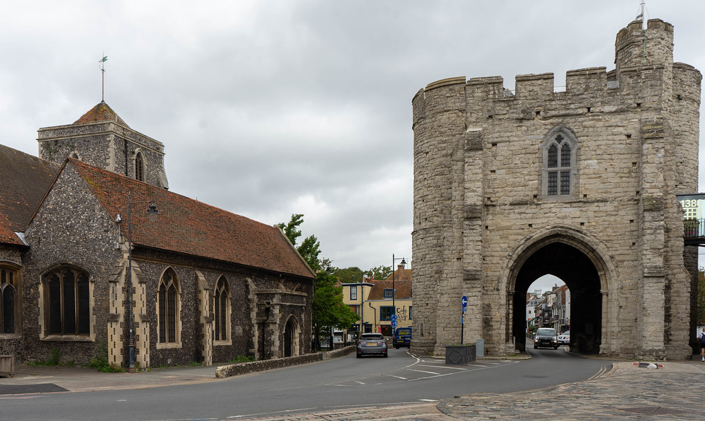 A photo of the Westgate Tower. A car is passing through underneath the tower.