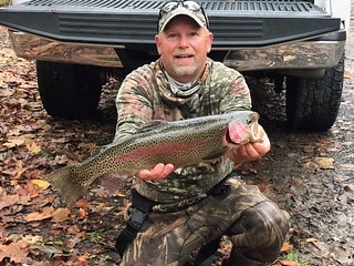 Photo of man holding a rainbow trout