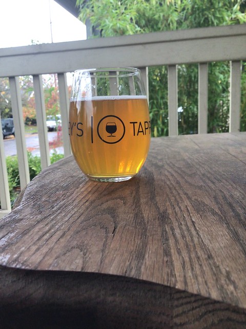 Revision Brewing's Dr Lupulin IIIPA in glass on table, outside