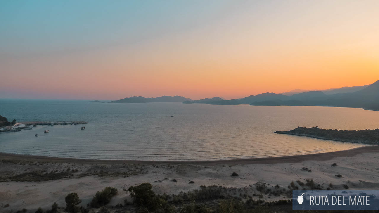 Bay and beach from a viewpoint at sunset. Orange colors typical of that time of the day. It is near Patara Beach. You can see small boats in the distance and an island