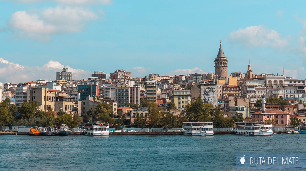 Houses and buildings of Istanbul seen from a boat on the Bosphorus. The Galata Tower stands out among them. Clear sky, clear day. 7 to 15 days in Turkey itinerary. 