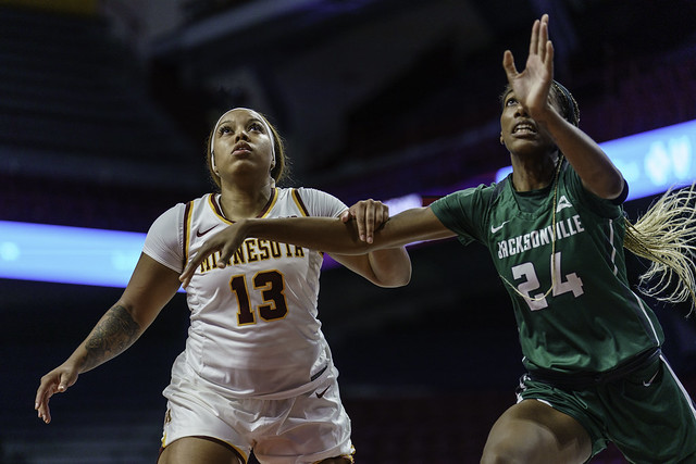 Guard Gadiva Hubbard (13) and Asiah Jones (24) look for a rebound in a Gopher game against Jacksonville