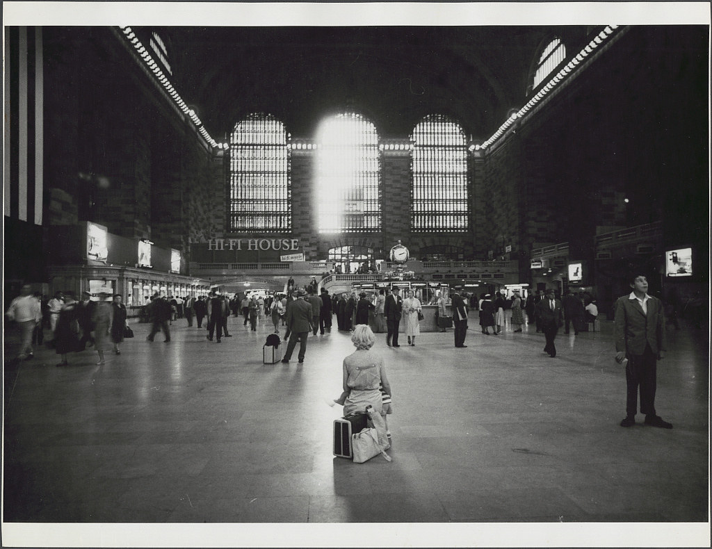 [Woman sitting on luggage in Grand Central Terminal] (LOC)