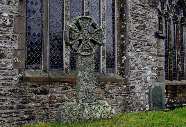 A lovely Cornish stone cross against the stained glass window of Lansallos Church.
