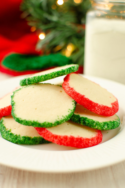 Stack of shortbread cookies with green and red sprinkles on a white plate