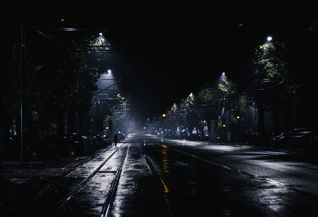 a girl walks alone at night