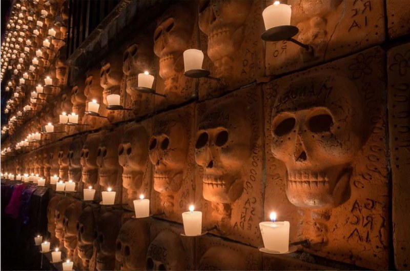 wall of skulls with candles.courtesy of Semanario Laguna