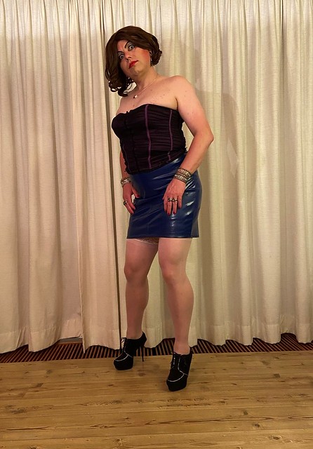 corset top and blue leather skirt