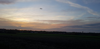 A plane, a sunset, and a distant view of May Hill
