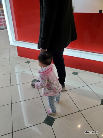 Toddler holding hands and walking inside Pacific Mall