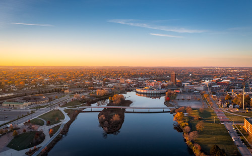 Sunrise over Downtown Aurora, Illinois by Drew Pertl, aurora drone morning glow sun sunrise golden hour rays downtown illinois aerial above haze