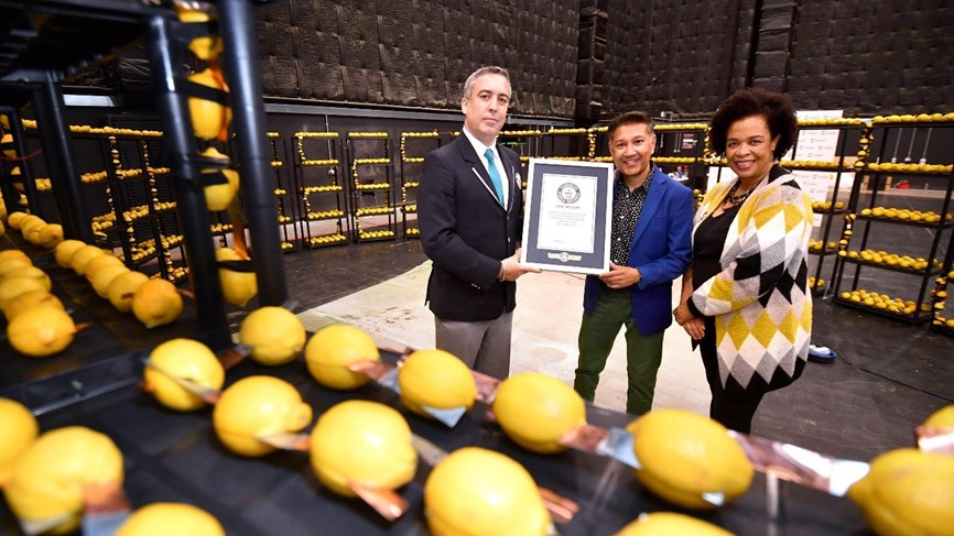 Saiful Islam holding record certificate with officials next to the lemon battery