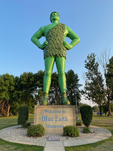 Jolly the Green Giant The Green Giant Statue is a symbol of the long standing association of the City of Blue Earth with the Green Giant company. Peas and corn are still grown and canned here today.

The statue arrived via flat bed truck on September 21, 1978 and was actually erected on the 23rd to preside over the Interstate 90 dedication.  He was hoisted in a sling b a 65 foot crane in the north roadside rest area - a point where east met west, marking I-90&#039;s completion and representing a 3,028 mile nonstop route from Boston to Seattle.

The statue was placed in his
current location on July 6, 1979. 
 Every winter he receives a red scar from Santa to protect him from the cold Minnesota weather.  The red scarf also pays homage to the old 1961 Green Giant
logo - a time when the company first entered the frozen food market.

55.5 feet tall
weights 8,000 pounds
Made of fiberglass
Wears a size 78 shoe
Smile stretches 48 inches
Cost $43,000 to manufacture

Jolly Green Giant Park @ Blue Earth, Minnesota