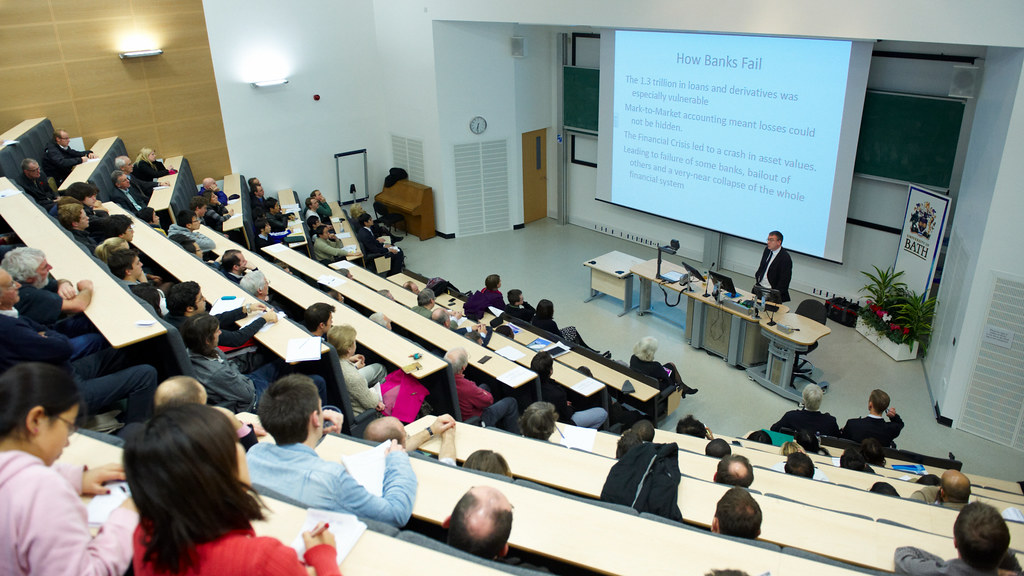 Dr Chris Martin gives a talk in a lecture room filled with people