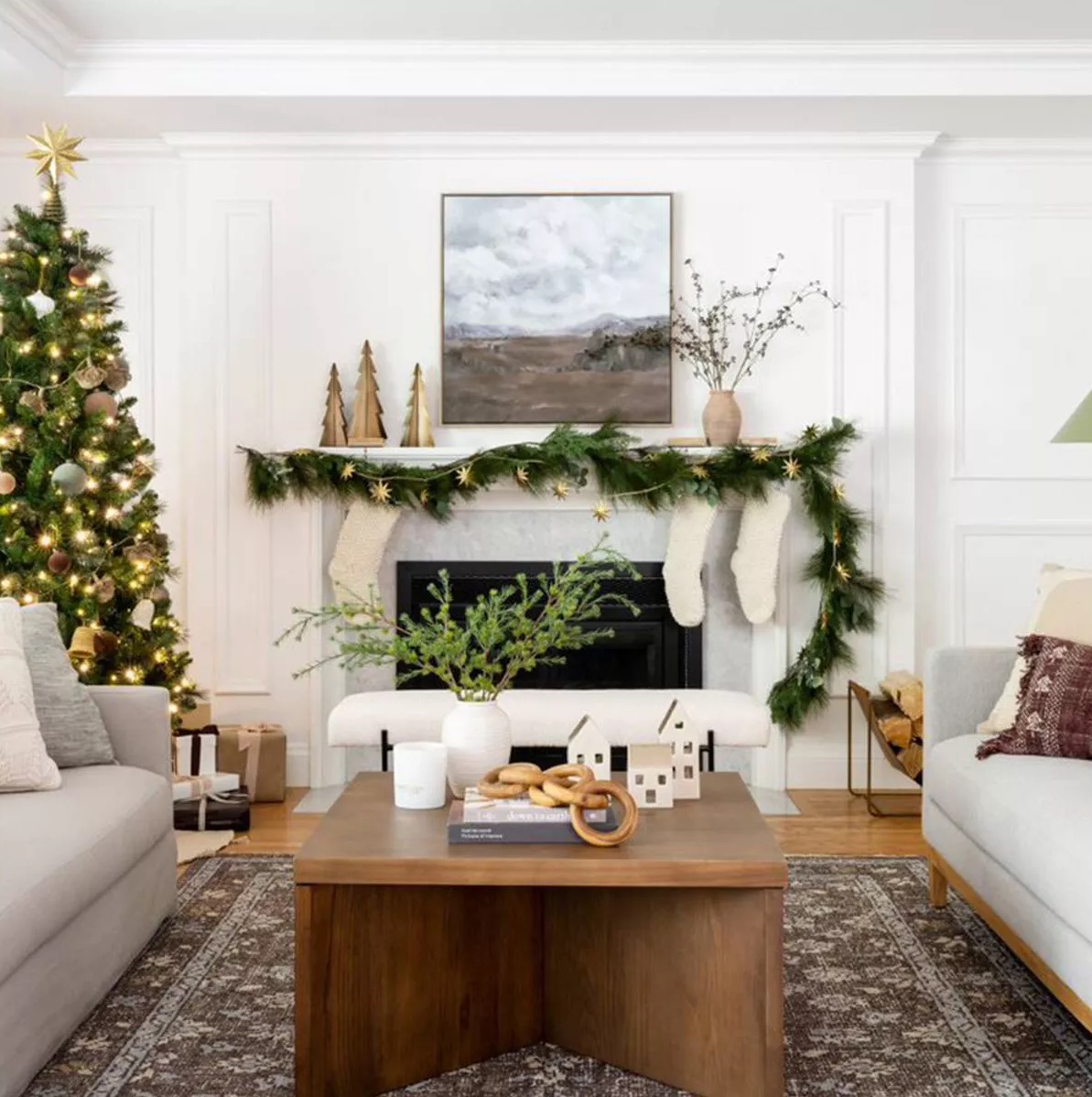 Neutral Christmas Living Room Decor | Wooden Mini Trees on Mantle with Greenery and Cream Knit Stockings by Threshold designed with Studio McGee at Target