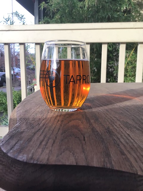 Ferment brewing's helles bock in glass on table outside, early winter afternoon. 