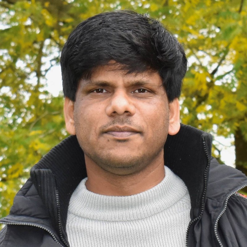 Profile image of Abhishek Kamble standing outside against a green background.