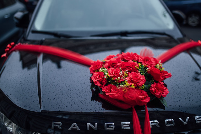 Beautiful wedding flower decoration on the hood of a car