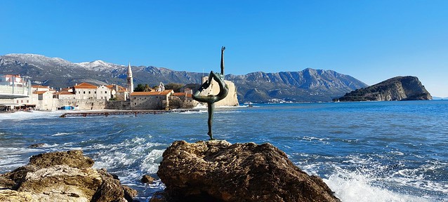ballerina, waves and the first snow on the mountains around Budva