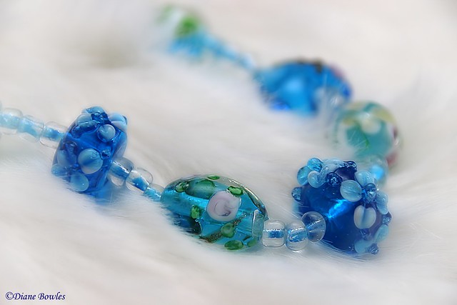Blue beads on white fake fur