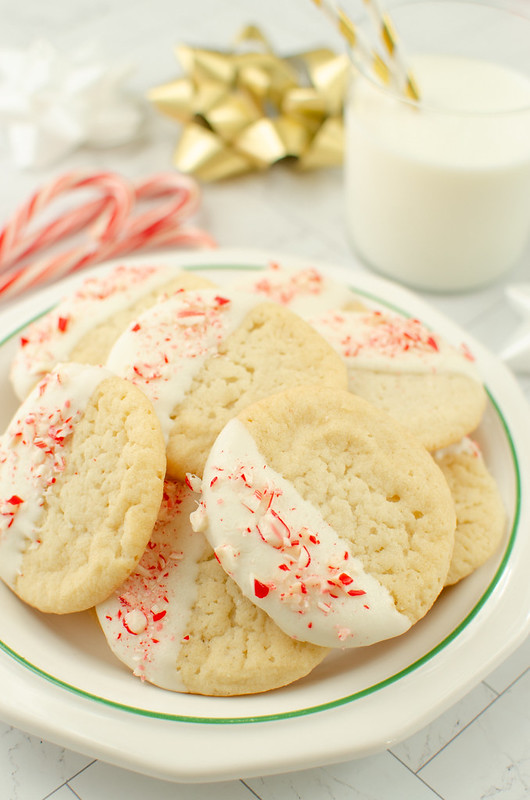 Sugar cookies coated in white chocolate and sprinkled with crushed candy canes