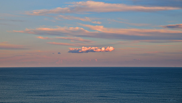 Small lonely cloud over the sea