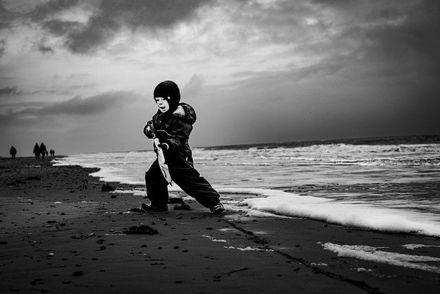 A little boy, fighting the sea.