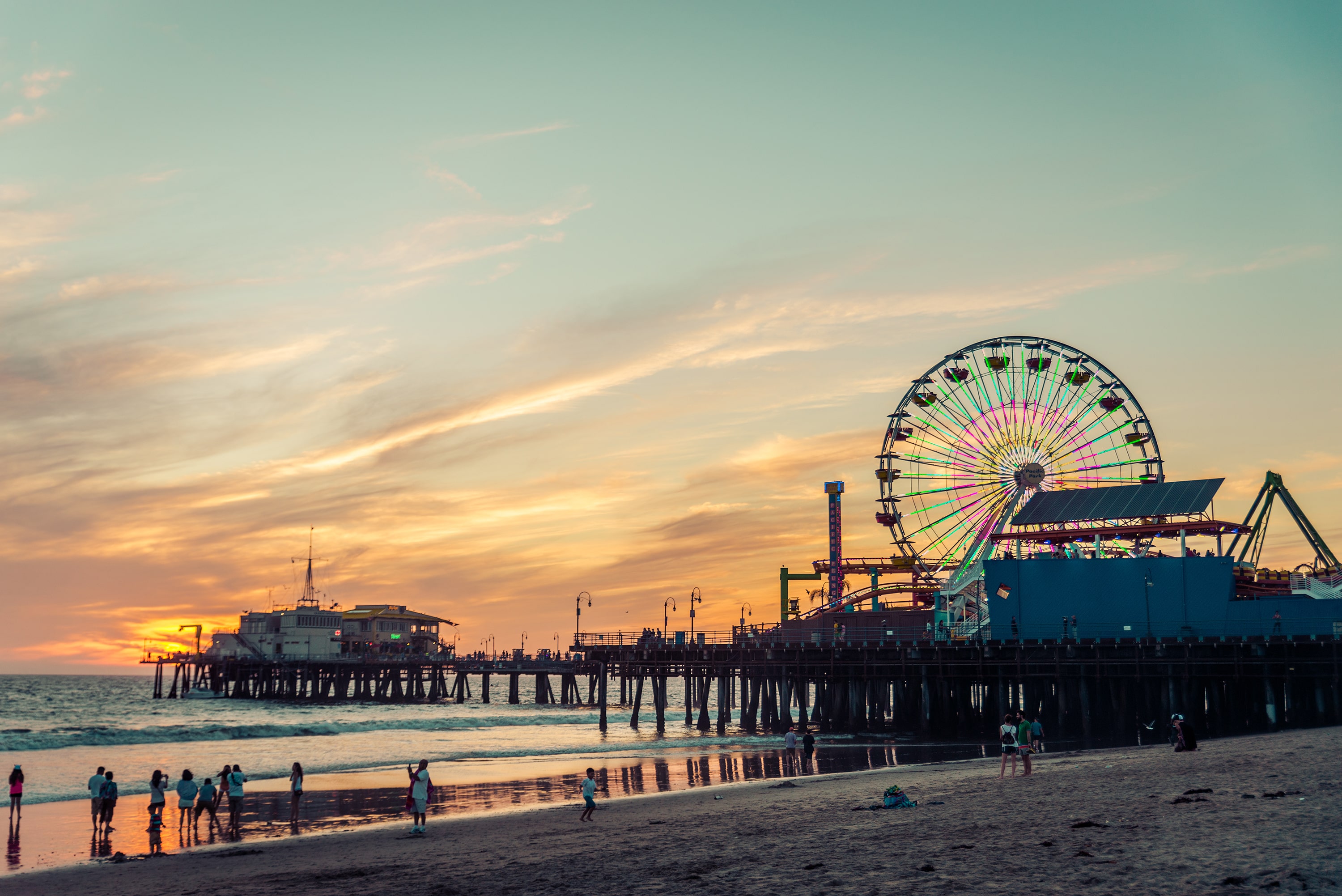 Santa Monica Pier at sunset. You can see the Ferris wheel and part of the beach.