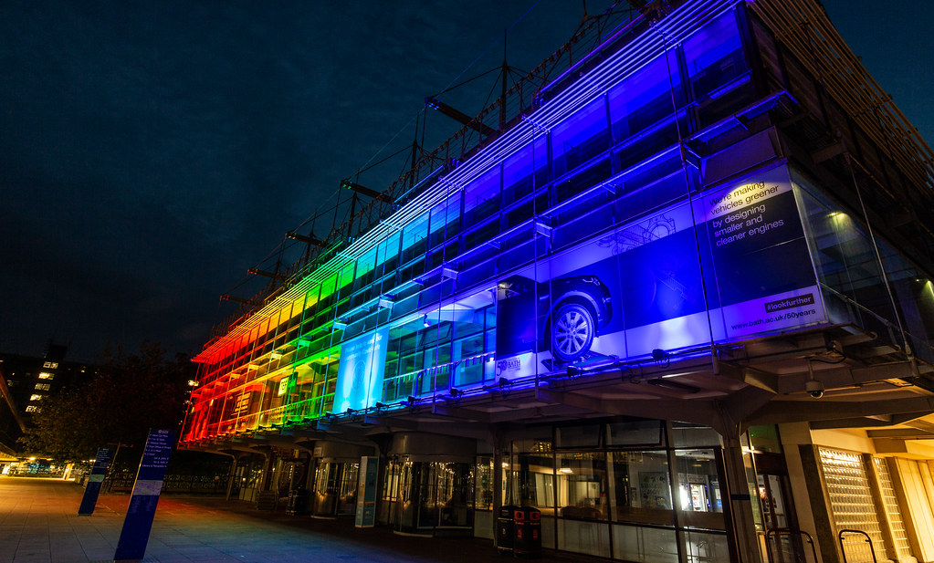 The Pride rainbow colours illuminate the façade of the University of Bath library