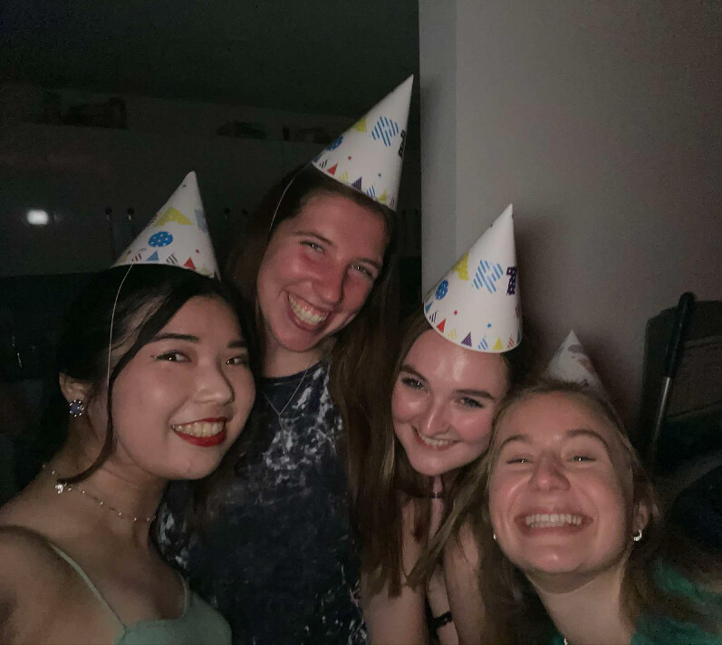 Macy (third from left) poses with her other international friends in birthday hats.