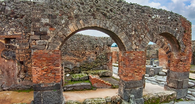 Arched building that once contained a street altar Pompeii Walk