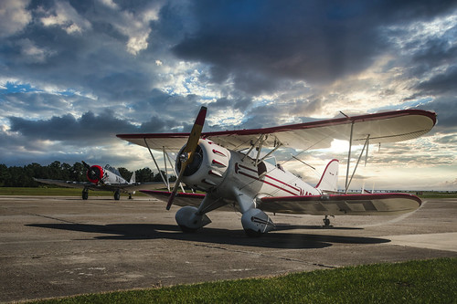 Airfield romantic by Christian Möller, Waco biplane and a North Amarican AT-6 at sunset

You can buy this picture here
<a href="https://www