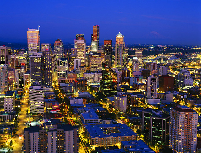 Retro image of Seattle skyline with Mount Rainier and city lights downtown corridor