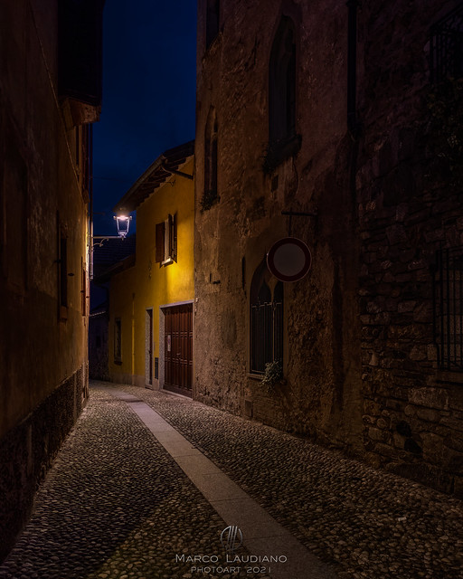 At night, through the alleys of Cannobio, Book VI