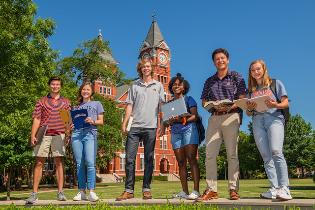 A group of Auburn students is shown on campus. 