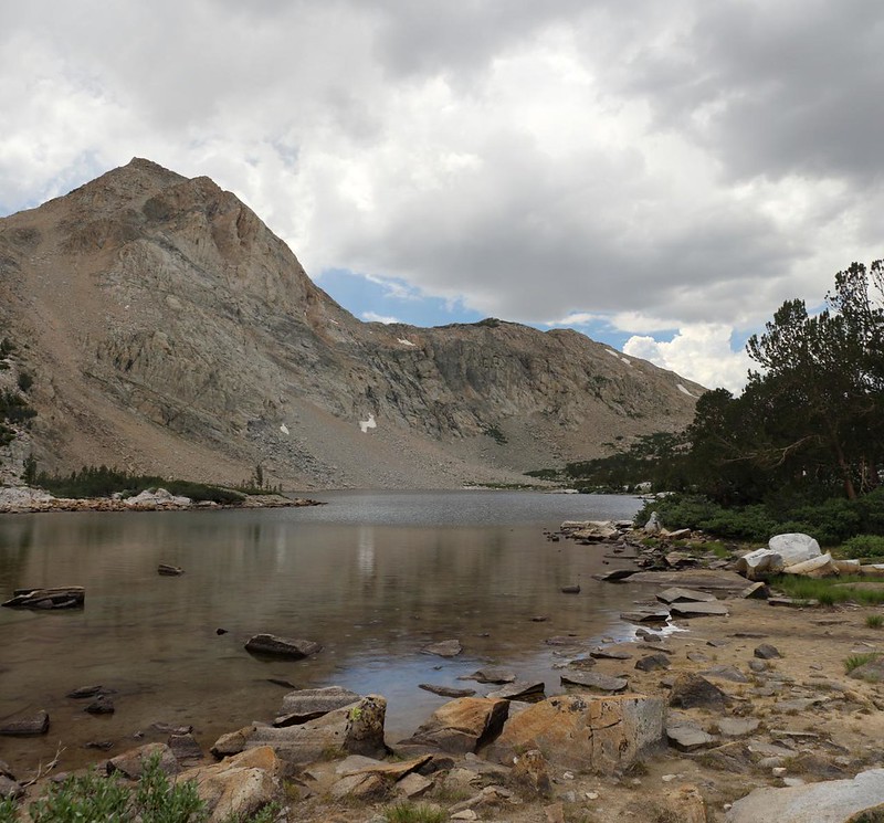 View over Piute Lake as it begins raining, with Peak 12353 on the left and Piute Pass on the right