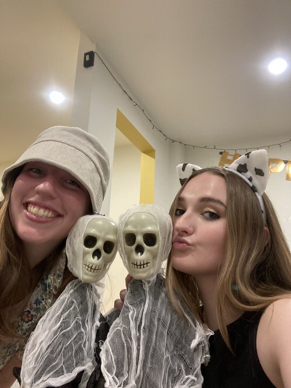 Selfie of Macy (right) with her friend Tille dressed up on Halloween with skeleton dolls. 