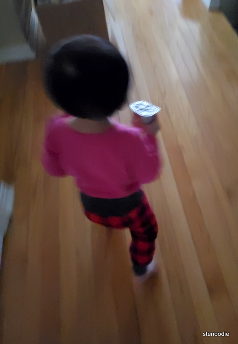 Toddler holding yogurt