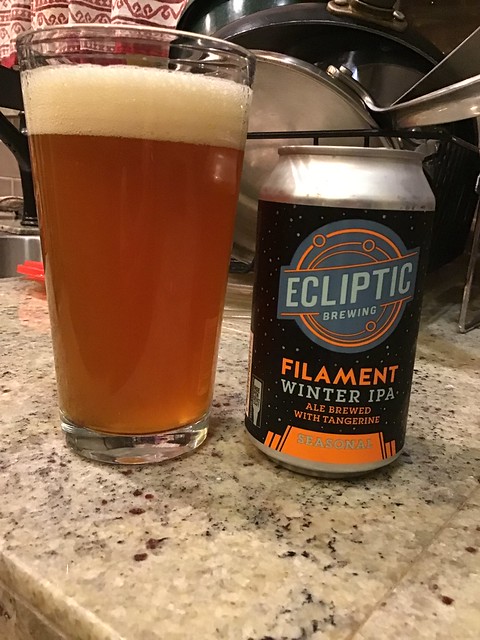 Ecliptic Filament winter IPA can next to glass of Filament ale. 