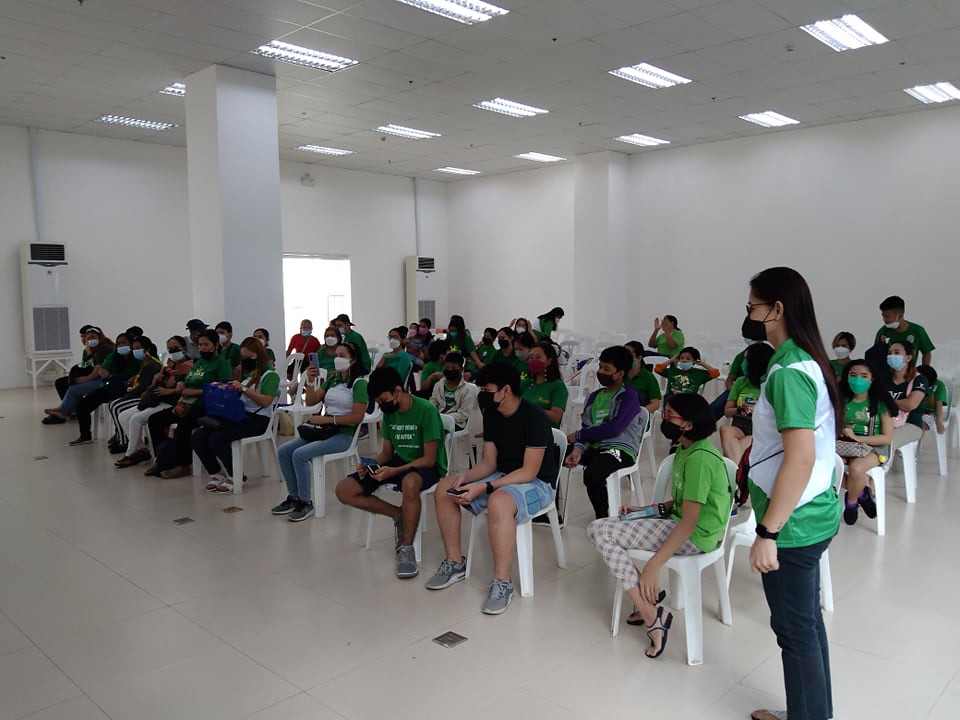 The image shows ASP Family mostly wearing green shirts, three wearing green with white, one wearing orange, red, black, dark grey and silver shirt.