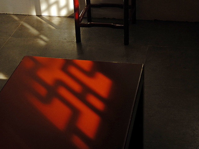 decorative screens cast patterned shadows on a dark red table in the Sun Yat Sen Garden in Chinatown, VancouverVancouver's