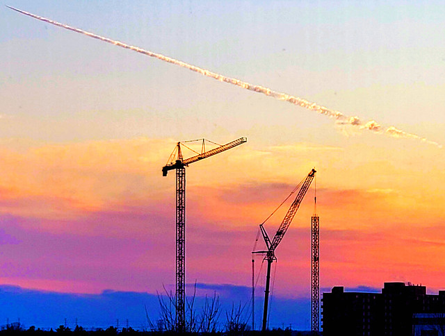 Vapour trails; cranes; sunset