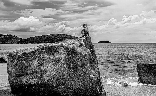 Child on a stone in Ao Sane beach (Phuket)