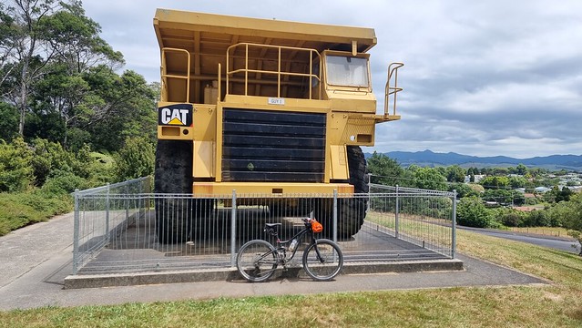 Big truck meets little bike at Martha Hill Opencast Gold Mine
