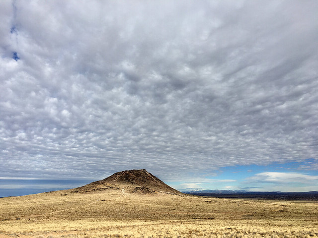 Albuquerque Vulcan volcano.  Sangre de Christo Mts. on the right, on the horizon.  New Mexico, USA.