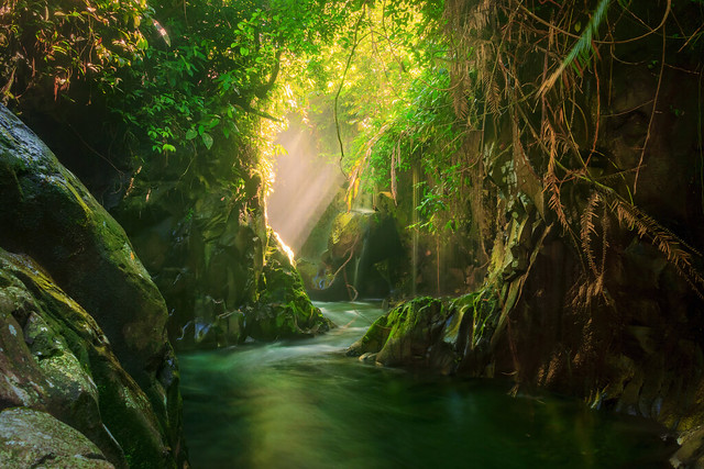 beautiful morning view at the stone tunnel waterfall in Indonesia's tropical forest